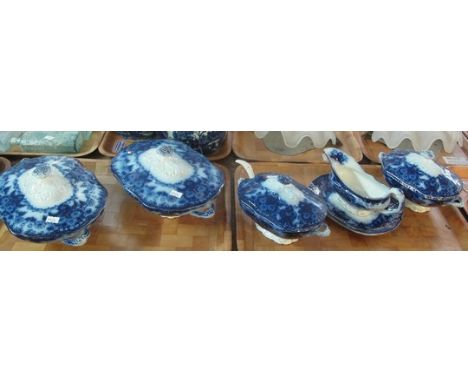 Four trays of Art Nouveau design 'Flow Blue' dinnerware comprising; tureens with ladle, graduated set of oval meat dishes, di