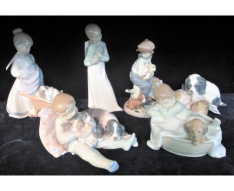 Six Spanish porcelain Nao and Lladro figurines and figure groups including; puppies. (6)(B.P. 24% incl. VAT)