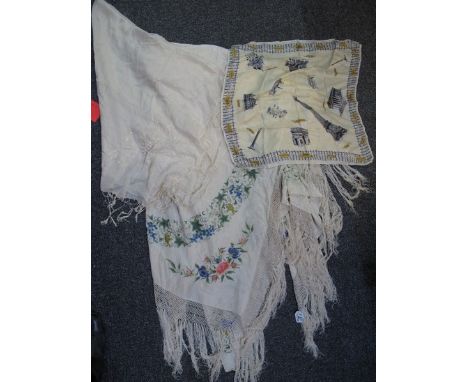 Floral and foliate design embroidered fringe edged shawl, together with a cream silk embroidered shawl and a Paris souvenir s