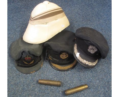 Box of mainly military items to include: various military caps, white gloves, two trench art cartridge cases, pith helmet wit