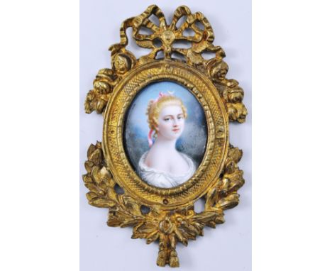 Oval enamel portrait miniature, young lady, head and shoulders length, in a gilt metal frame.