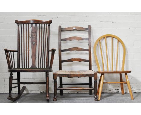 Stained beechwood comb back rocking chair, wheel splat, upholstered seat, 58cm, a rush seat ladder back chair and an Ercol ty