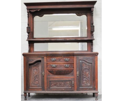 Victorian carved walnut sideboard, bevelled mirror back under a canopy with a shelf and a further mirror panel, drawers and c
