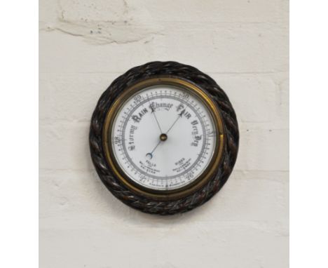 Oak cased aneroid wall barometer, rope twist outline, diameter 25cm.