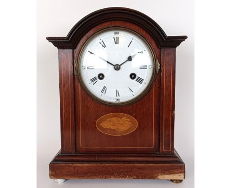 An mantel clock, with an eight day movement, in an inlaid mahogany case, 30 cm high