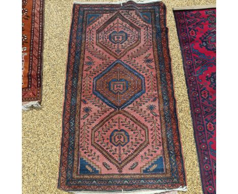A Persian type machine made carpet, and 3 other rugs, and a cushion