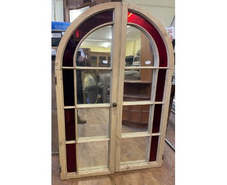 A mirror, made from a pair of domed top cupboard doors, 137 cm x 94 cm