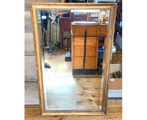 A mahogany framed mirror, 175 cm high, a standard lamp, 139 cm high, another, and a wall mirror, 100 x 60 cm (4)