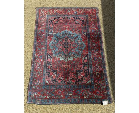 A Persian red ground rug, 212 cm x 144 cm