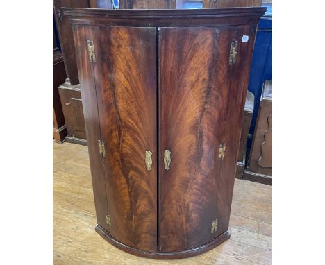 A mahognay bow fronted corner cabinet, 68 cm wide