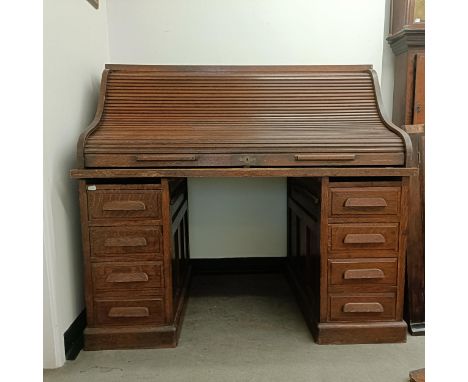 An early 20th century oak roll top desk, 140 cm wideTambour front Roll is working, various losses and wear as expected throug