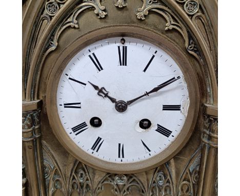 A mantel clock, with an enamel dial and a twin train eight day movement, in a brass gothic style case, 54 cm highdial chipped