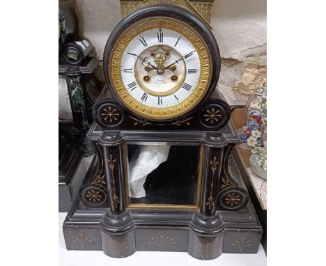 A mantel clock, the enamel dial with a visible anchor escapement, to a twin train eight day movement, in a polished slate cas