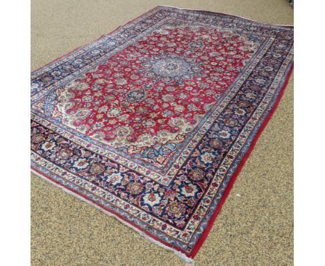 A Persian red ground carpet, 442 x 300 cm