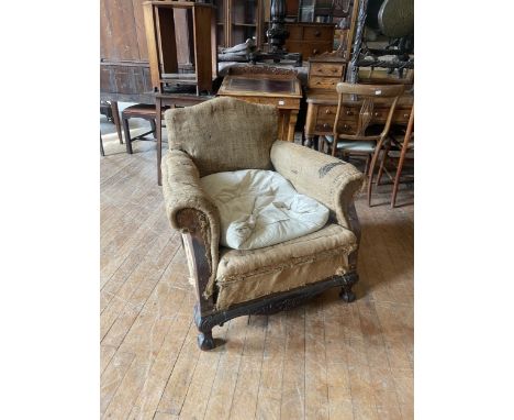 An early 20th century upholstered armchair, with ball and claw feet