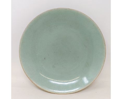 A Chinese celadon ground plate, 28 cm diameterwould benefit from a clean, small surface cracks to both sides, chip to rim, gl