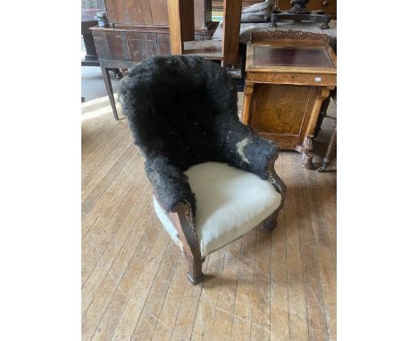 A 19th century upholstered armchair, with an oak frame