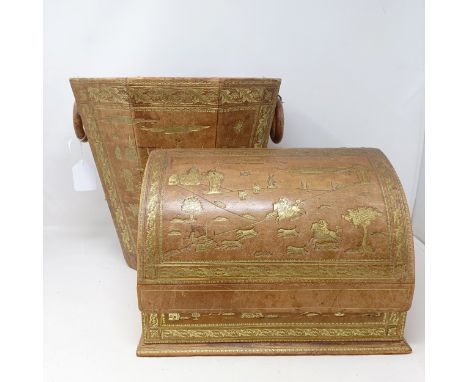 A late 19th/early 20th century tooled leather desk stand, decorated a hunting scene, 29 cm wide, and a matching waste paper b