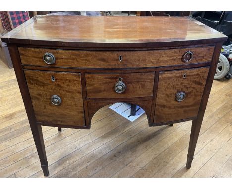 A mahogany bow fronted table, with four drawers, 90 cm wide