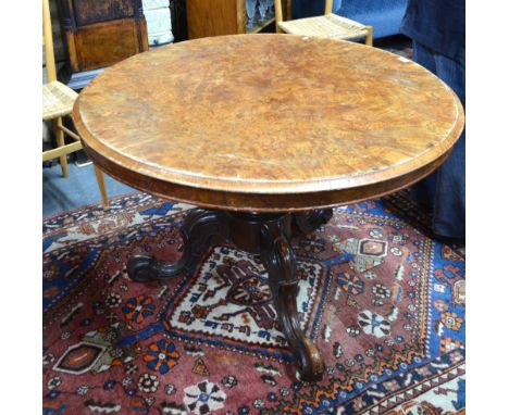 A Victorian quarter veneered burr walnut breakfast table, the circular tilt top raised on a moulded support to hipped tripod 