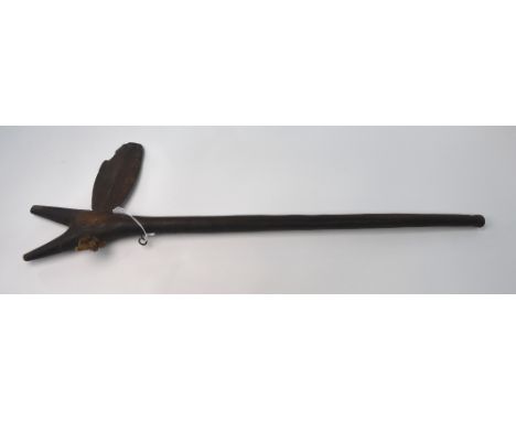 A 19th century African tribal hardwood hunting axe, the shaft with forked head and fitted with a flared steel axe blade secur