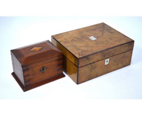 A Georgian yew wood tea caddy with boxwood-strung borders and canted lid, mother of pearl shield keyhole escutcheon (interior