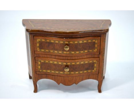 A late 19th century miniature model of a serpentine commode chest of two long drawers, executed in burr yew and walnut in the