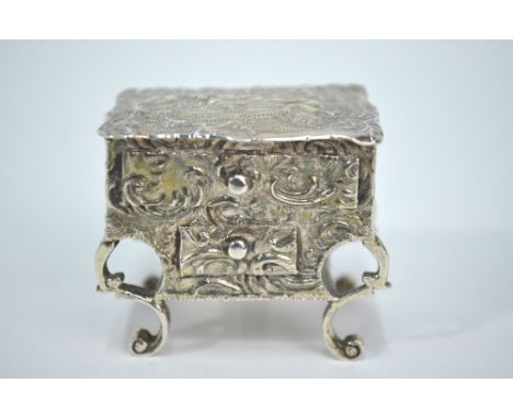 A late Victorian silver novelty pill-box in the form of a rococo table, richly chased with cherubs and scrolling foliage, Joh