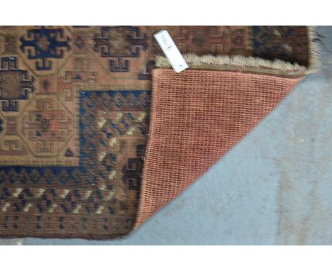 A Persian Hakhi Balouch, geometric design on light brown ground with contrasting border, 140 x 80 cm
