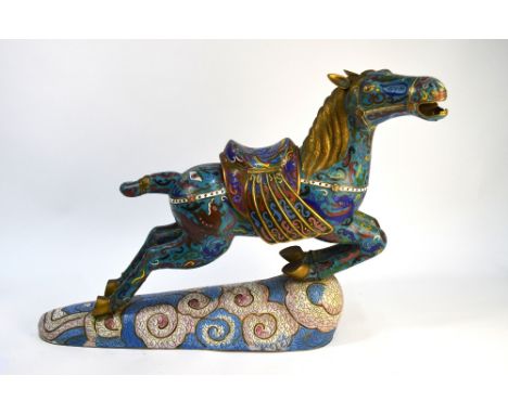 A Chinese cloisonne enamel figure of a prancing horse, looking to the right; with white surcingle and associated, removable s