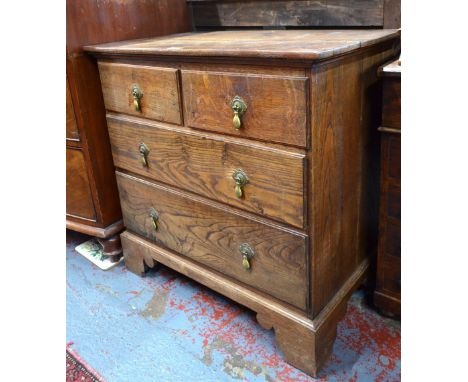 A small 18th century oak/elm chest of two short over two short drawers, raised on shaped bracket feet, bears retailers plate 