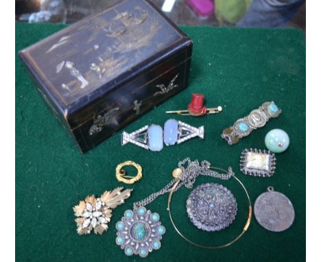 A collection of vintage jewellery including Art Deco dress buckle, top hat and cane brooch, Egyptian style brooch, scarab pen