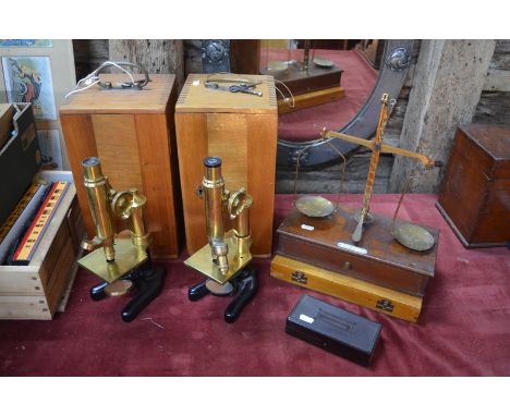 Two Leitz brass compound microscopes by E. Leitz, Wetzlar, nos. 81844 and 99556, in teak cases, to/w a case of slides, a fold