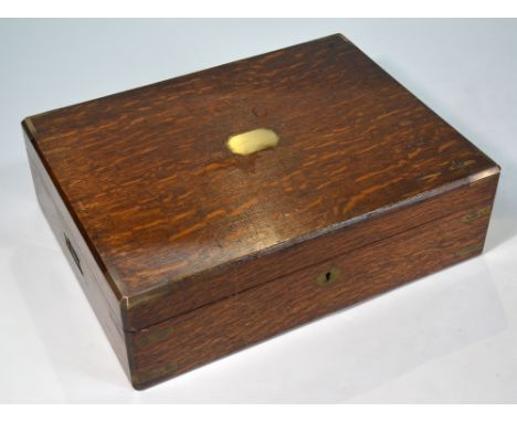 An Army & Navy brass-bound oak canteen box, the blue baize-lined interior fitted with a tray (no lock or contents), 45 cm wid