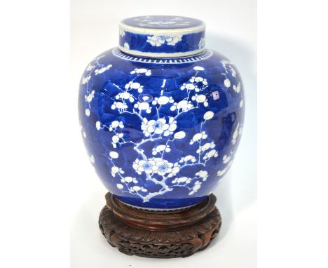 A blue and white, Chinese porcelain, oviform prunus jar and cover, decorated with a typical design of plum blossom, 24cm high
