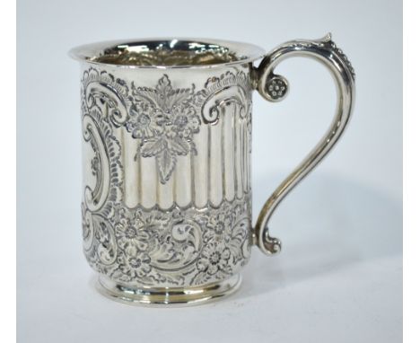 A late Victorian silver Christening mug, embossed and chased overall with floral and scroll designs and reeding, scroll handl