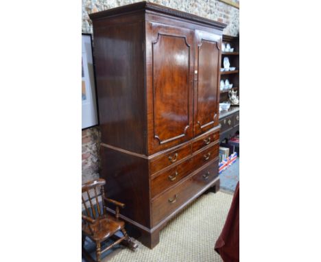 A Victorian mahogany dwarf linen press having a pair of panelled doors enclosing three oak slides, over two short over two lo