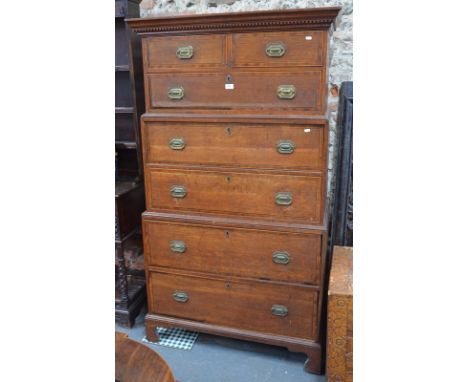 An unusual Georgian oak chest of two short and five long drawers with rosewood crossbanded fronts, in three stepped sections 