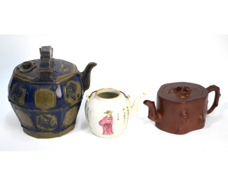 Three Asian ceramic teapots, comprising: an austere Yixing stoneware teapot and cover; a famille rose teapot without cover, d