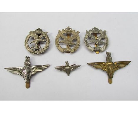 Two British Parachute Regiment cap badges with King's Crown, another, two Glider Pilot Regiment cap badges and an Army Air Co
