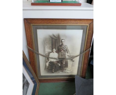 A WWI portrait photograph of a British Army serviceman, oak framed, glazed