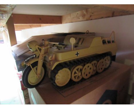 A box of military action figures and a Kettenkrad German military vehicle model 