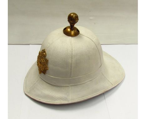 A Gibraltar regiment pith helmet with white canvas covering, George VI crown badge  