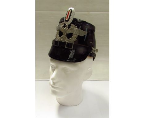 A Third Reich era city Shako helmet, in black with eagle, wreath and swastika badge, four vent holes. Provenance: The vendor 