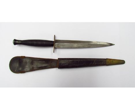 A Second pattern Fairbairn Sykes third pattern commando dagger with leather scabbard