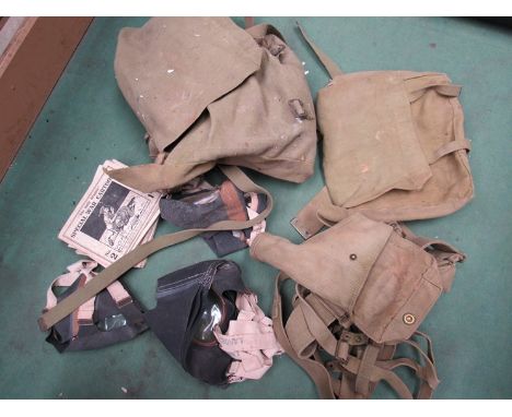 Two boxes of mixed WWII era and later British military items including 1940 dated webbing, pith helmet and Civil Defence unif