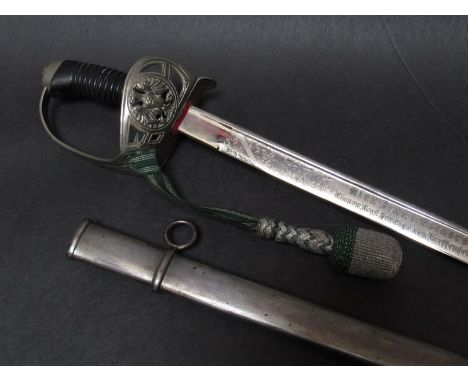 An Imperial German Army 16th Prussian Ulan Regiment officer's sword with Bakelite ribbed grip, folding guard set with green a