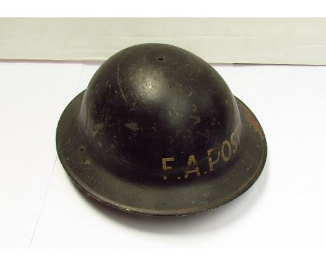 A British Type II helmet, painted in black with F.A post (Field Artillery) lettering  