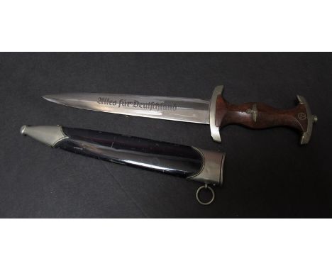 A Third Reich era German NSKK mans dagger by Carl Eickhorn, Solingen with brown hardwood grip set with roundel and eagle insi