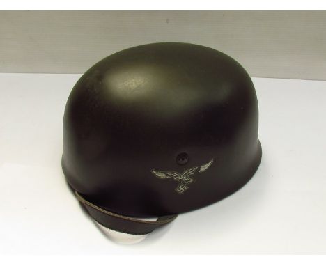 A reproduction German paratroopers helmet made from fibreglass, size 58